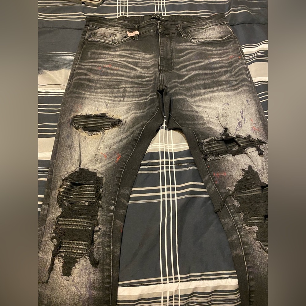 Distressed black denim.